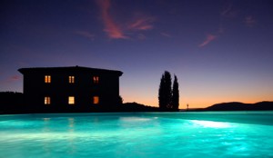 night potography of tuscan villa pool